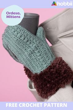 a pair of knitted mittens sitting on top of a white glove with brown trim