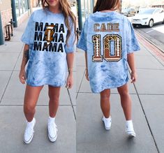 "This cute custom Football Mama Shirt is perfect to wear for your child as a personalized Game Day Mama Football shirt. This Mom Football Shirt comes with the football design letters and numbers! These personalized football mom shirts make wonderful gifts to show such proud support including her customized kid's football number and name on the back of your football Game Shirt! Any Game day Sports Mom would love this football season tee and they are perfect football team gifts as well! * This is a normal relaxed fit Comfort colors Color blast Dyed shirt. * For an oversized tee, please size up 1-2 sizes based off your measurements on the size chart provided. * If you are wanting an oversized \"Sleep shirt/Dress shirt\" look, we recommend sizing up 3 sizes. * Please review the size chart to e Football Mom Outfits Black Women, Collegiate Customizable T-shirt For Football Season, Casual Customizable Football Season T-shirt, Customizable Fan Apparel T-shirt For Game Day, Customizable Casual T-shirt For Football Season, Mom Football Game Outfit, Collegiate Custom Print T-shirt For Football Season, Collegiate T-shirt With Custom Print For Football Season, Customizable Sublimation Short Sleeve For Game Day