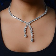 a woman wearing a diamond necklace on her neck