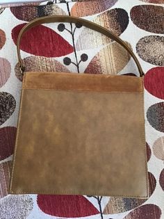 "Vintage 1960's 1970's Brown genuine Suede and Vinyl handbag. The handle is shorter and not able to put on the shoulder. Fully lined. Has an inside slip pocket as well as a zippered side pocket. (I have a pair of matching shoes listed in my shop. Please check if they are still available). *MORE INFORMATION BELOW* CONDITION: I note the inside zippered pocket has a tear in the lining. Difficult to photograph as the pocket is small. I also note a small wear area on the edge of the flap of the purse Vintage Hobo Shoulder Bag For Evening, Vintage Hobo Tote Bag For Evening, Vintage Hobo Satchel Bag For Evening, Mid-century Brown Shoulder Bag For Travel, Vintage Handheld Hobo Bag For Travel, Vintage Hobo Bag With Double Handle For Shopping, Vintage Hobo Shoulder Bag With Detachable Handle, Vintage Double Handle Hobo Bag For Shopping, Mid-century Satchel Shoulder Bag For Travel