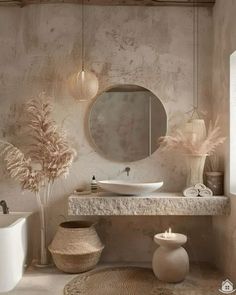 a bathroom with a sink, mirror and vases on the counter next to it