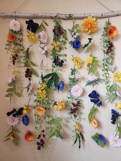 a bunch of flowers are hanging on the wall