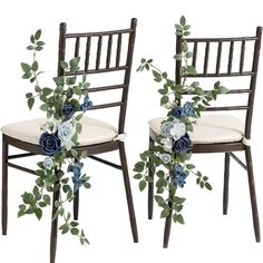 two chairs decorated with blue flowers and greenery