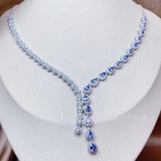 The main design elements of the necklace include multiple pear-shaped cuts of blue tanzanite, each gemstone is surrounded by small white diamonds, creating a shiny contrast effect. Tanzanite has a high degree of transparency and luster. The necklace as a whole adopts a streamlined design, gradually extending from the middle to the two sides, which is very elegant. The exquisite workmanship of the whole necklace highlights the quality of fine jewelry, which is perfect for dinner or formal occasio Tanzanite Necklace, Streamlined Design, Blue Tanzanite, Classic Metal, Natural Tanzanite, Silver 925 Necklace, Unique Handmade Jewelry, Cartilage Earrings, Gold Plated Earrings