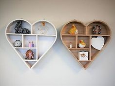 two heart shaped shelves are hanging on the wall