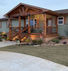 a house with a porch and stairs in the front yard