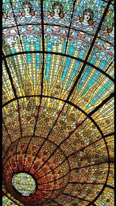 the inside of a glass ceiling with many different colors and designs on it's sides