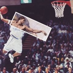 a basketball player jumping up into the air to dunk a ball in front of an audience