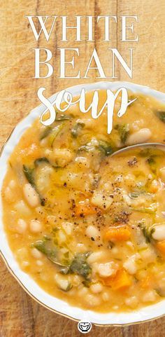 a white bean soup in a bowl on a wooden table with the words, white bean soup