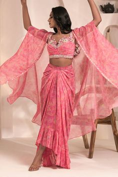 Pink tie dye printed cape with hand embellishments. Comes with coordinating draped dhoti skirt and 3D floral hand embellished blouse. - Aza Fashions Traditional Georgette Sets With Cape Sleeves, Diwali Sets With Zari Work And Cape Sleeves, Bollywood Saree With Cape Sleeves For Diwali, Fitted Sets With Cape Sleeves For Diwali, Designer Wear Saree With Pallu And Cape Sleeves, Bollywood Style Sets With Zari Work And Cape Sleeves, Traditional Sets With Cape Sleeves For Diwali, Bohemian Fitted Sharara With Sheer Dupatta, Bohemian Pre-draped Saree With Resham Embroidery