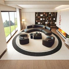 a modern living room with black leather furniture and large windows overlooking the countryside in the distance