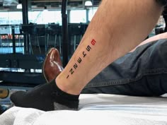 a man with a tattoo on his leg that reads, i love you suzukifud