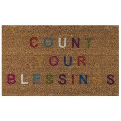 a door mat with the words count your blessing written in multicolored letters on it