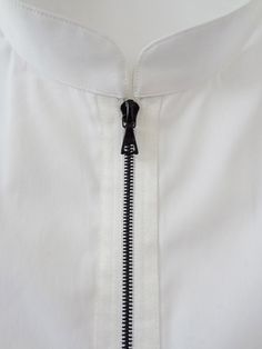 an open zipper on a white shirt