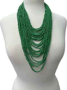 Elevate your style with this stunning, authentic African necklace featuring multiple strands of beautiful green beads. Handcrafted using brass metal, this beaded necklace exudes a unique ethnic and regional style that will make a statement. Perfect for any occasion. Colour : Green Length - 34cm Green Statement Necklace, Green Beaded Necklace, African Necklace, Turban Headwrap, Green Beads, Wooden Earrings, Beaded Necklaces, Body Jewellery, Cuff Bangles