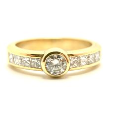 a yellow gold engagement ring with channel set diamonds