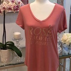 Super Soft Short Sleeve T-Shirt With Gold Lettering That Says Rose Is Always The Answer. This T-Shirt Is So Soft. I Have The Exact Same Shirt But In Small. This One Is A Medium. New With Tags And Has Never Been Worn. The T-Shirt Is A Little Bit On The Long Side. I Would Say It Kind Of Goes Past The Hips At Least On Me. I’m Not Very Tall. Gorgeous Dusty Rose Color. Gold Lettering. V-Neck. The Fabric Is Super Soft. And Rose Is Always The Answer For Everything!. Non-Smoking Household Fast Shipper Pink V-neck Graphic Tee Top, Pink V-neck Graphic Tee, Short Sleeve Rose Print Tops For Summer, Summer Graphic Tee With Rose Print, Rose Print Tops For Summer, Casual Rose Print Summer Shirt, Casual Rose Print Shirt For Summer, Short Sleeve Rose Print Graphic Tee Tops, Spring Graphic Tee With Rose Print