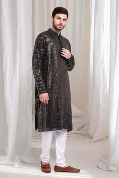 Black kurta with striped sequin work embroidery. Paired with solid churidaar. - Aza Fashions Sequin Traditional Wear For Party In Transitional Season, Traditional Party Wear With Sequins For Transitional Season, Sequin Traditional Wear For Party And Transitional Seasons, Navratri Long Sleeve Embellished Kurta, Black Embellished Kurta For Festive Occasions, Long Sleeve Embellished Kurta For Navratri, Embellished Long Sleeve Kurta For Navratri, Black Sequined Wedding Kurta, Black Kurta With Zari Work For Celebration