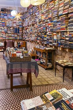 a room filled with lots of books and tables