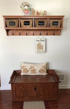 a wooden bench with two baskets on top of it and a sign above the bench