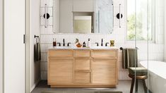 a bathroom with a sink, mirror and bathtub