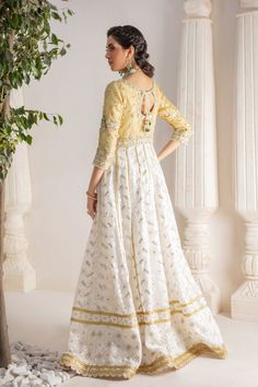 A contemporary Classic - Over a canvas of Pure chikankari chiffon, features a beautiful floral embroidered bodice further enhanced with dabka, sequins, pearls and kundan work. This classy peshwas is paired with gorgeous kamdani work dupatta, making this an absolute favorite for nikkah, engagement & other celebratory festivities Hand crafted tassels & straight pant completes the look of this outfit. Peshwas Fabric: Pure Chiffon Peshwas Length: 60” (customisable, mention in order notes) Sleeve length: 16” Pant Fabric: Khaadi Silk Dupatta Fabric: Georgette Chiffon Color: Ivory & Gold This outfit is fully lined, neck key-hole can be lined on request, mention in order notes. Please refer Size Guide Before selecting size For Customised measurements please select Custom size for an additional 20$ Chanderi Sharara With Intricate Embroidery In Maxi Length, Chanderi Sharara With Intricate Embroidery, Embellished Chanderi Embroidered Fabric For Wedding, Anarkali Style Embellished Cream Sharara, Elegant Embellished Chanderi Lehenga, Embellished Semi-stitched Chanderi Dress, Reception Dress In Tissue Silk With Dabka Work, Dabka Work Dress For Reception, Transitional Tissue Silk Dress With Zari Work