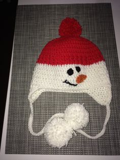 a crocheted hat with a snowman face on it