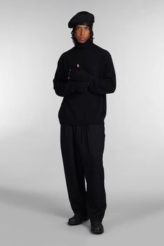 Knitwear in black wool, high collar, long sleeves, back print, ribbed cuffs and bottom, 100% wool, Made in Japan, Model is 1. 83 and wears size 3 Black Stretch Sweater With Ribbed Cuffs, Black Turtleneck Sweater For Work, Stretch Black Turtleneck, Black Turtleneck For Workwear In Fall, Black Turtleneck For Fall Workwear, Black Funnel Neck Sweater For Layering, Black High Neck Turtleneck For Work, Casual Black Turtleneck For Work, Black Turtleneck For Winter Layering