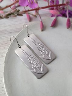 Fireweed Dangles The Fireweed is a raised design.  Stainless Steel - 1.25 x 1 inch in size.  Steel earwires. Arrives on a jewelry card and shipped in a jewelry box or tin. Dangle Etched Earrings As Gift, Etched Dangle Earrings As Gift, Etched Dangle Earrings For Gift, Course Ideas, Jewelry Card, Jewelry Earrings Dangle, 1 Inch, Jewelry Box, Dangle Drop Earrings