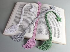 an open book with crocheted necklaces on it