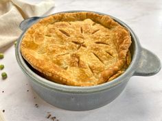 a pie sitting in a pan on top of a table next to a napkin and spoon