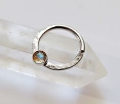 This sterling silver silver septum ring is handmade by me from sterling silver hard wire.  Soldered onto the bottom is a 3mm sterling silver setting with a 3mm labradorite stone set inside of it.  The ring is available in 16, 18, and 20 gauge and you can also choice between 10mm and 8mm for the diameter. *NOTE* To open ring twist to the side to keep its shape.  The thicker gauges will be more difficult so it is best to have your piercer put it in for you. RETURNS AND SIZING: Please be aware of y Wedding Septum Ring, Septum Ring Aesthetic, Small Septum Ring, Small Septum, Bijoux Piercing Septum, Cute Septum Rings, Silver Septum Ring, Daith Ring, Septum Piercing Jewelry