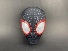 - This is a Miles Morales mask that I designed and made based on "Spiderman: Into the SpiderVerse". - Its characteristic is that the fabric is specially customized, after continuous testing and modification, the color can be restored perfectly. - I depicted the masks one by one with reference to the movie footage. Through constant adjustments, the mask is brought closer to the state in the movie. - There is a three-dimensional pattern on the surface of the mask, and if you look closely at the photo, you will see that it is exactly the same as in the movie. - Three-dimensional pattern on the surface of the mask and looks more three-dimensional and linear. - Inside the mask there is a 3D printed face shell to keep the mask in the best condition. - The face shell is plastic, three-dimensional Black Masks For Cosplay Costume Events, Black Themed Mask For Cosplay Events, Black Themed Masks For Cosplay Events, Themed Black Masks For Cosplay Events, Black Full Face Masks For Costume, Black Full Face Masks For Costumes, Full Face Black Costume Mask, Black Masks For Halloween Themed Events, Black Halloween Masks For Themed Events