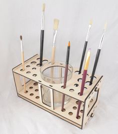 a cup holder with eight brushes in it