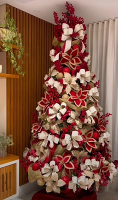 a christmas tree decorated with ribbons and bows