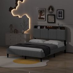 a bed room with a neatly made bed and some pictures on the wall above it