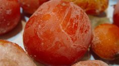 some oranges are sitting on a white plate