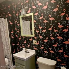 a bathroom with flamingos on the wall and a white sink in front of it