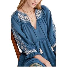 Broad Ruffle With Elegant Embroidery At The Neck And Sleeves And Feminine Appeal To This Tie-Neck Top By Free People. - Tie Closure - V-Neck - 3/4 Blouson Sleeves. Casual Blue Embroidered V-neck Top, Blue Bohemian Blouse With Embroidered Hem, Blue Cotton Embroidered V-neck Top, Blue Bohemian Blouse With Geometric Embroidery, Bohemian Blue Blouse With Geometric Embroidery, Blue Bohemian Embroidered Top, Casual Blue Top With Embroidered Neckline, Casual Blue Embroidered Top With Neckline Detail, Blue V-neck Embroidered Top With Floral Details