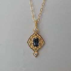 Introducing our stunning Cairo-inspired Blue Sapphire Necklace, a captivating homage to the architectural splendor and artistic finesse of the enchanting city of Cairo. Drawing inspiration from the intricate decorations adorning Cairo's historic buildings. At the heart of the necklace gleams a magnificent blue sapphire, evoking the serene depths of the Nile River as it winds its way through the bustling streets of Cairo. Upon closer inspection, one can find tiny floral motifs, meticulously craft Cairo Drawing, Elegant Blue Necklaces With Rose Cut Diamonds, Elegant Sapphire Jewelry With Intricate Design, Heirloom Blue Necklaces For Weddings, Art Deco Gold Sapphire Jewelry, Heirloom Diamond Necklace With Intricate Design, Elegant Blue Filigree Necklace, Elegant Blue Engraved Necklace, Elegant Engraved Blue Necklace