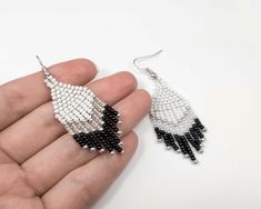 Style meets simplicity in these chic Black and White Woven Chevron Earrings. Handcrafted with love and attention to detail, these earrings are the epitome of minimalist elegance, making them a perfect addition to your jewelry collection. The classic black and white color combination is a timeless choice, ensuring these earrings effortlessly complement any outfit, from casual to dressy. The woven chevron design adds a touch of sophistication and uniqueness, setting these earrings apart from the o Minimalist White Beaded Dangle Earrings, Minimalist White Beaded Drop Earrings, Minimalist White Beaded Earrings As Gift, Minimalist White Beaded Earrings For Gifts, Minimalist White Beaded Earrings Gift, Earrings Casual, Chevron Earrings, Black And White Earrings, Casual Earrings