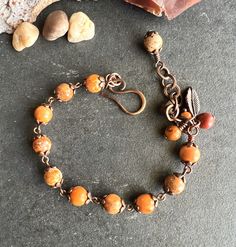 Gorgeous fall BRACELET made with 8mm red-orange Imperial Jasper beads. In one end of the bracelet there is a hand-forged small hook, antiqued, and sealed to protect the finish. In the other end an extender (chain) with wire-wrapped Jasper beads and a copper plated leaf. This bracelet is size S/M, fits 6.5" to 8" wrists (with the extender). I can add beads and make it a little bigger (at no extra cost). Please measure your wrist with a flexible tape, and leave your size in NOTES at CHECKOUT. EXTRA SMALL: 5.5" to 6.5" SMALL: 6.5" to 7.5"    MEDIUM:  7.5" to 8.5" LARGE: 8.5" to 9.5"  **To make this bracelet I used natural gemstones. They have characteristics and color variations that make them unique and beautiful** PHOTOS: I take all the pictures with natural light, doing my best to accurate Fall Bead Jewelry, Adjustable Red Nature-inspired Jewelry, Adjustable Orange Bracelets With 8mm Beads, Hand-strung Orange Spiritual Bracelets, Orange Bracelets With Natural Stones For Gifts, Hand-strung Orange Jewelry With Round Beads, Orange Hand-strung Spiritual Bracelets, Orange Natural Stone Bracelets As Gift, Orange Bracelet Jewelry Gift