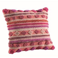 a pink and purple striped pillow sitting on top of a white wall