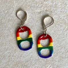 the earrings are made out of plastic and have rainbow colors