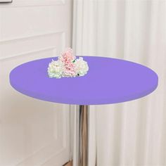 a small purple table with flowers on it