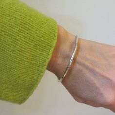 "This handmade heirloom quality sterling silver bangle is such a classic! Made from 3.2mm wide solid round sterling silver, it has such a pleasing weight. It is hand-formed and forged by me... the silver then gets hammered, hammered and hammered some more, creating a surface fully covered in tiny facets that provide a perfectly understated sparkle. The silver has been lovingly sanded and given a polished finish. Available in smooth (unhammered) finish as well, as can be seen in the last two pics Minimalist Hammered Sterling Silver Bangle, Minimalist Hammered Sterling Silver Bangle Bracelet, Sterling Silver Oyster Bracelet For Anniversary, Everyday Silver Jubilee Bracelet, Minimalist Sterling Silver Bangle With Shiny Finish, Minimalist Hammered Silver Bangle, Minimalist Silver Hammered Bangle, Classic Hammered Bracelets As Gift, Classic Hammered Bracelets For Gifts