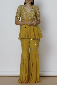 Yellow scallop kurta and sharara with placement mirror work. 
Components: 2
Neckline: V-shaped neckline
Sleeve Length: Half
Fabric: Crepe,Shantoon
Color: Yellow
Mirror embroidery
Kurta with front slow
Closure:
Kurta: Side zip
Sharara: Side hook,zip - Aza Fashions Garara Dress, Bride Fashion Photography, Luxurious Outfits, Sharara Designs, Indian Bridesmaid Dresses, Haldi Outfits, Mehndi Dresses, Kurta Sharara Set, Yellow Embroidery