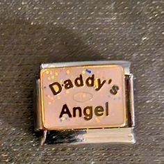 a badge that says daddy's angel on it