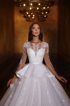 a woman in a white wedding dress posing for the camera