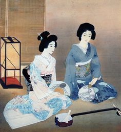 two geisha women sitting on the ground